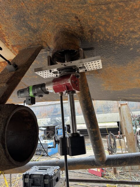Line boring machine mounted to rudder tube during marine repair project.