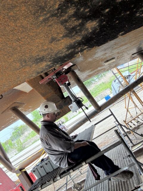 Mactech field machinist monitoring portable line boring operation under vessel.