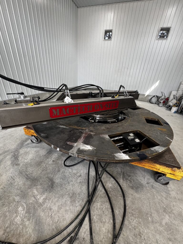 Portable flange milling machine set up beneath a 144-inch diameter flange